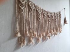 there is a wall hanging with tassels on it