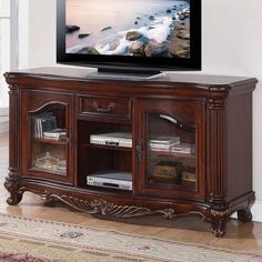 an entertainment center with a flat screen tv on top