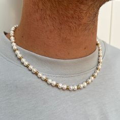 This Gold Bead & Shell Pearl chain is individually strung for an elegant look. Perfectly sized at 6mm, the pearls are combined with stainless steel for a timeless, unisex piece. Accessorise any outfit year-round with this stylish Necklace.  Pair with our Bracelet for the set! DETAILS Pearl size: 6mm (approx) Materials: Made from Shell Pearls & Stainless Steel / 18K Gold PVD Plating Necklace clasp: Lobster Lifetime Warranty Packed in a Luxury Twistedpendant Jewellery Pouch SIZE DETAILS The model Classic Pearl Necklace With Beaded Chain For Gift, Men’s Pearl Chain, Pearls On Men, Classic Beaded Pearl Necklace, Classic Gold Pearl Necklace With 8mm Beads, Men’s Pearl Necklace, Mens Pearl Necklace, Men's Necklace Gold, Pearl Chain Necklace