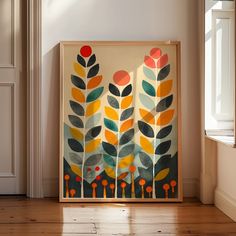 an abstract painting is displayed in front of a window on the floor next to a door