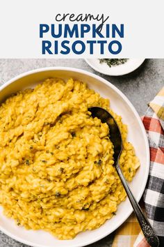 creamy pumpkin risotto in a white bowl with a serving spoon on the side