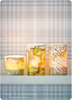 three vases sitting next to each other on a shelf in front of a window