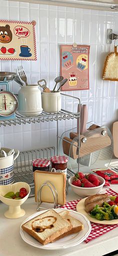 there are many different foods on the counter in this kitchen, including bread and fruit