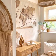 a room with a wooden table, wicker chairs and a map on the wall