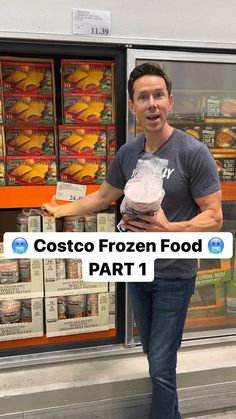 a man standing in front of a store holding a bag of frozen food and looking at the camera