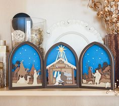 three wooden nativity scene pieces on a shelf