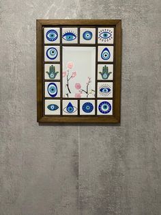 a decorative mirror mounted to the side of a wall