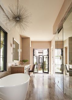 a bathroom with a large bathtub next to a doorway