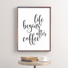 a framed poster with the words life begins after coffee on it next to a table