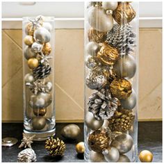 two tall clear vases filled with ornaments