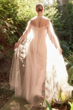 This stunning Andrea And Leo -A1219 gown is meticulously crafted from pearl pleated tulle fabric. A cape featuring an asymmetrical pleated hem adds unique drama to the look. It's perfect for any special event. Pearl Gown, Tulle Outfit, Andrea And Leo, Gown With Cape, Seductive Dress, Tulle Cape, Fairytale Gown, Gown For Prom, Blush Wedding Dress