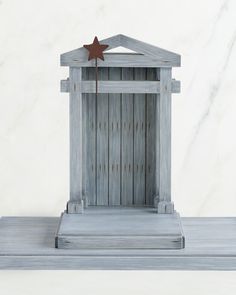 a small wooden structure with a star on top