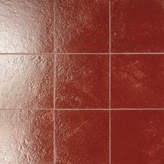 a red tiled wall with white grouting