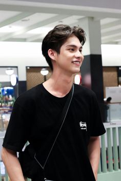 a young man is standing in an airport