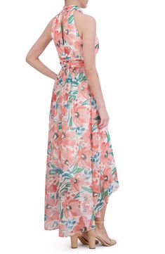 Bring the garden to the party in a flower-filled dress designed for flow with a high-low hemline. 43" to 57" center front length (size 8) Hidden back zip; keyhole with button-and-loop closure High neck Sleeveless, with cutaway shoulders Partially lined 100% polyester Hand wash, dry flat Imported High Neck Sleeveless, Chiffon Gown, Eliza J, Floral Sleeveless, The Garden, High & Low, High Low, Designer Dresses, High Neck