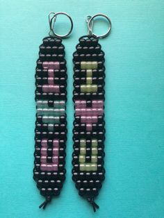 two black and pink beaded key chains with the word love spelled in small letters