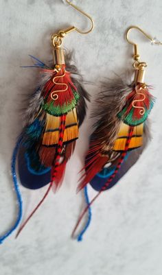 This unique long Bohemian earrings is perfect gift for her. This  hand made feather earrings they are modern elegant and made just a little bit different.  If u are on the hunt for the perfect handmade jewelry that will hold its meaning for years to come you landed  in right place. Perfect for weddings / bridesmaids gifts / parties, birthday gifts, fancy dress.    This customizable earrings makes the perfect gift for mom.   This listing is for 1 pair of your choosing :  -navy  -  yellow Making Feather Earrings, Native Feather Earrings, Bohemian Peacock Earrings For Gift, Bohemian Peacock Earrings As Gift, Multicolor Feather Jewelry For Festivals, Peacock Bohemian Earrings For Gift, Peacock Bohemian Earrings As Gift, Peacock-colored Bohemian Earrings For Gift, Bohemian Peacock Design Earrings For Party