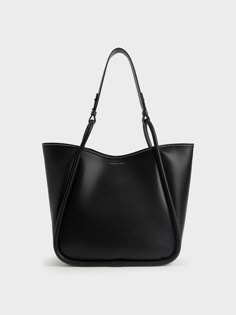 Elegance with a wear-anywhere appeal, this oversized tote bag is a must-have for any style-conscious minimalist. A sleek all-black finish is easy to incorporate into your wardrobe, while the roomy interior makes for ample storage space. If you need more, it also comes with a detachable inner pouch. Oozing versatile understated charm, this trans-seasonal tote bag will look brilliant with a patterned shift dress and flats for an effortless look. Large Designer Bags, Black Work Bag, Charles And Keith Bags, Slouchy Tote Bag, Charles And Keith, Photographie Indie, Uni Bag, Circle Handle, Slouchy Tote