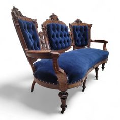 three chairs with blue velvet upholstered on the back and arms, all in different styles