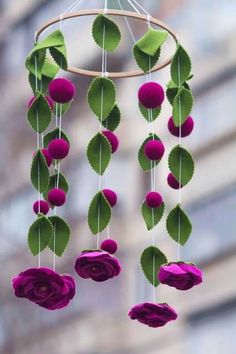 a mobile with flowers hanging from it's sides