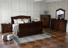 a bedroom scene with focus on the bed, dresser and mirror in the middleground