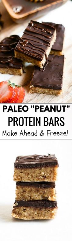 chocolate peanut protein bars stacked on top of each other with strawberries in the background