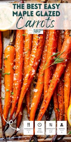 the best easy maple glazed carrots recipe on a baking sheet with lemon wedges