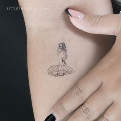 a woman's hand with a small tattoo on her left side ribcage