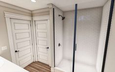 an empty bathroom with two doors and a stand up shower