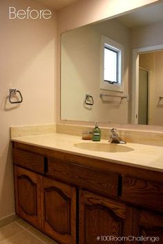 a bathroom with a sink, mirror and towel dispenser on the counter