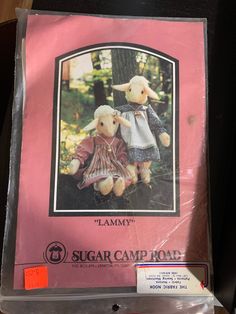 a pink book with an image of two stuffed animals on it