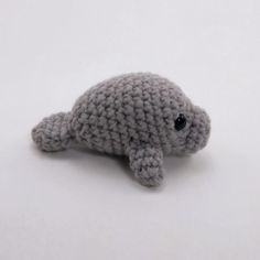 a crocheted stuffed animal laying on top of a white surface