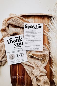 an assortment of items displayed on a wooden platter with thank you note attached to it