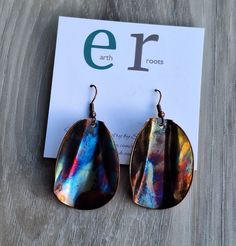 These unique hand made earrings feature copper blanks that have been shaped for design and then fire painted using a propane torch to bring out the different colors in the metal. NOTE:  Certain types of lighting will bring out the colors more than other types of lighting. These earrings measure just over2" inlength. They will ship in a gift box via USPS with tracking info provided. Artsy Copper Drop Earrings, Artsy Nickel-free Copper Earrings, Nickel-free Copper Artsy Jewelry, Artsy Nickel-free Copper Jewelry, Artistic Copper Earrings With Patina, Nickel-free Multicolor Copper Earrings, Multicolor Nickel-free Copper Earrings, Artistic Copper Earrings, Artistic Brown Copper Earrings