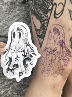 a person with a tattoo on their arm next to a sticker that says ghost