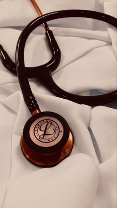 a stethoscope laying on top of a white sheet