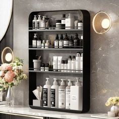 a black shelf with lots of bottles on top of it in front of a mirror