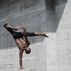 a man doing a handstand on some steps