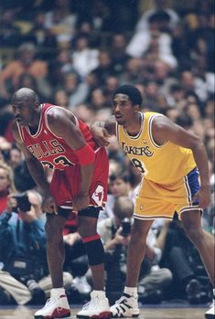 two basketball players standing next to each other