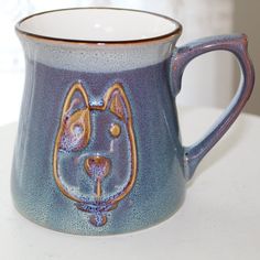 a blue mug with a dog's face on it