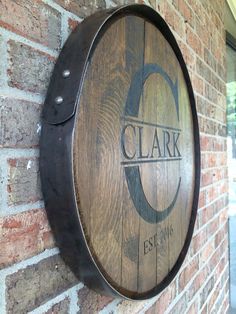 a wooden barrel mounted to the side of a brick building