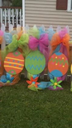 easter decorations on the grass in front of a house