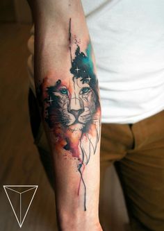 a man with a tattoo on his arm that has a lion's face painted on it