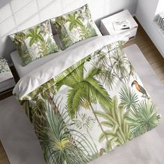 an image of a tropical themed bedding with birds and palm trees on the sheets