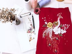 a table topped with different types of thread and sewing supplies on top of a white surface