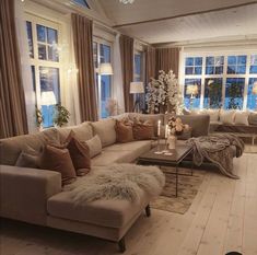 a living room filled with furniture and lots of windows