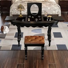 a bed room with a neatly made bed and a vanity