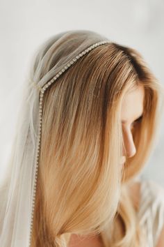 a woman with blonde hair wearing a veil