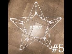 a star is drawn on the floor with white paint and some words written in it