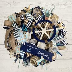 a wreath made out of marine themed items with a starfish and ribbon on it